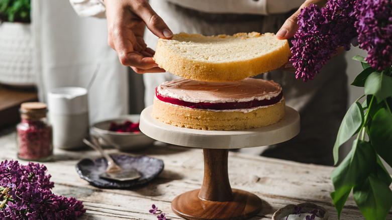 chef stacking sponge cakes