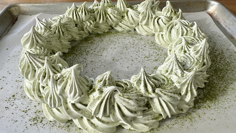 Matcha powder dusted over pavlova