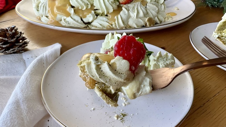 Forkful of matcha berry pavlova wreath