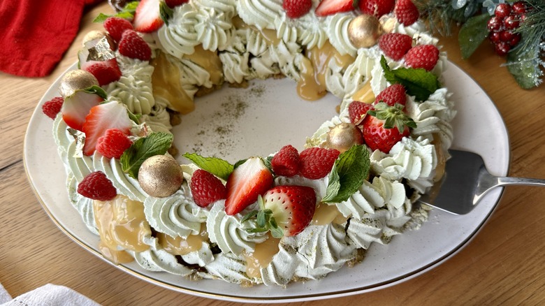 Serving matcha berry pavlova wreath