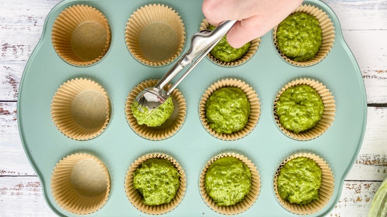 scooping batter into muffin tin