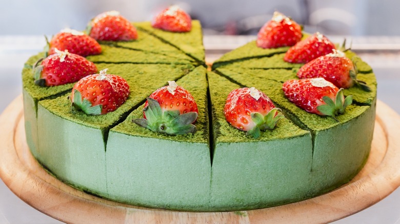 A matcha green tea cake with strawberries