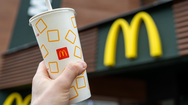 person holding cup at McDonald's