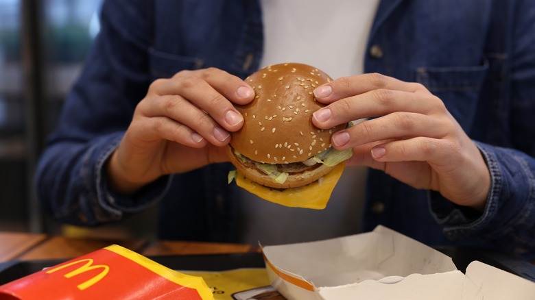 Person eating a McDonald's burger