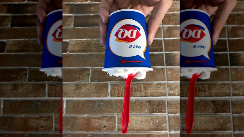A hand holding a Dairy Queen Blizzard upside down