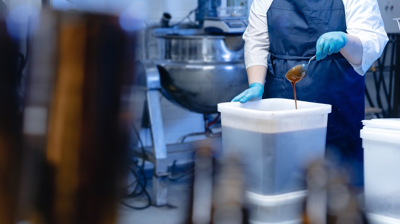 worker pouring honey for mead