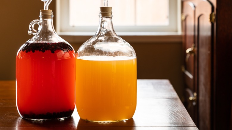 Two jars of mead being brewed on a table