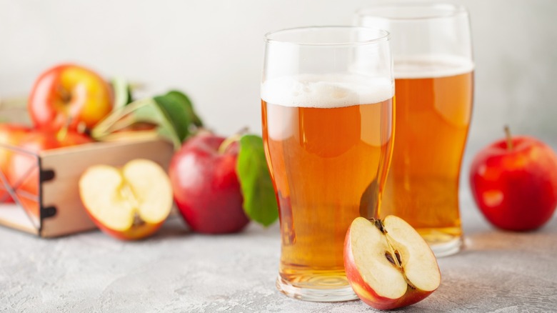 Two glasses of cider with apples