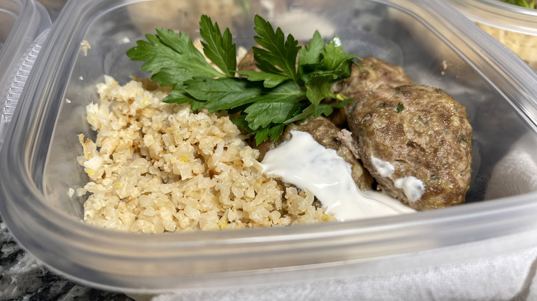 rice, yogurt, meatballs, herbs in container