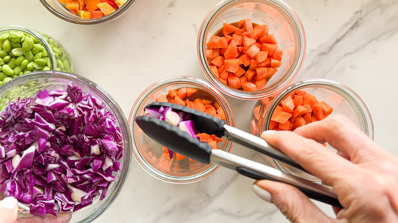 adding cabbage to jar