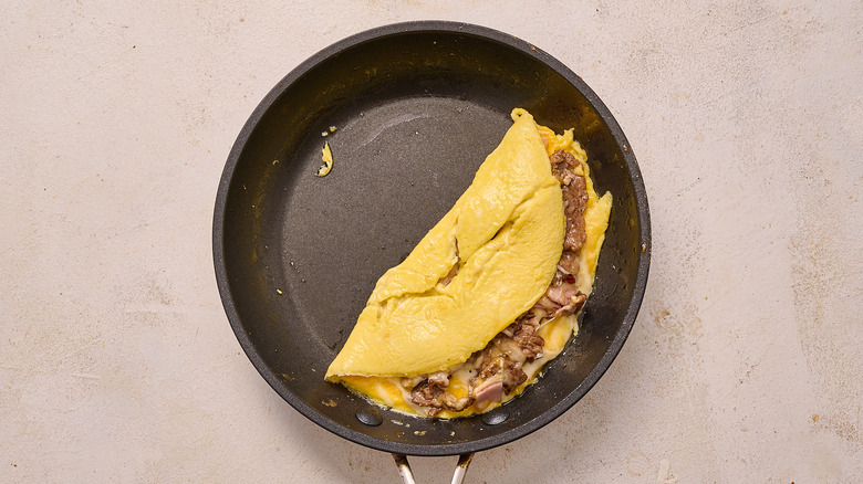 omelette folded in half in skillet