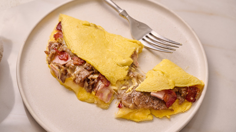 eating an omelette with a fork
