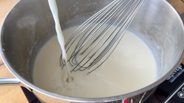 whisking milk into mixture