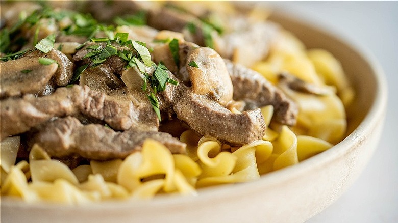 beef on noodles with parsley