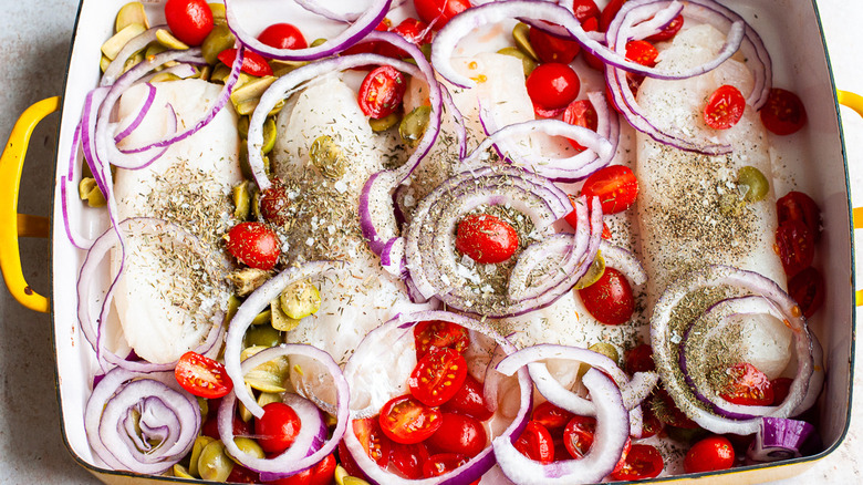 pan of cod and raw vegetables