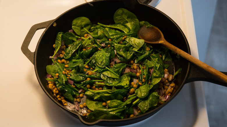 skillet containing lentils and spinach