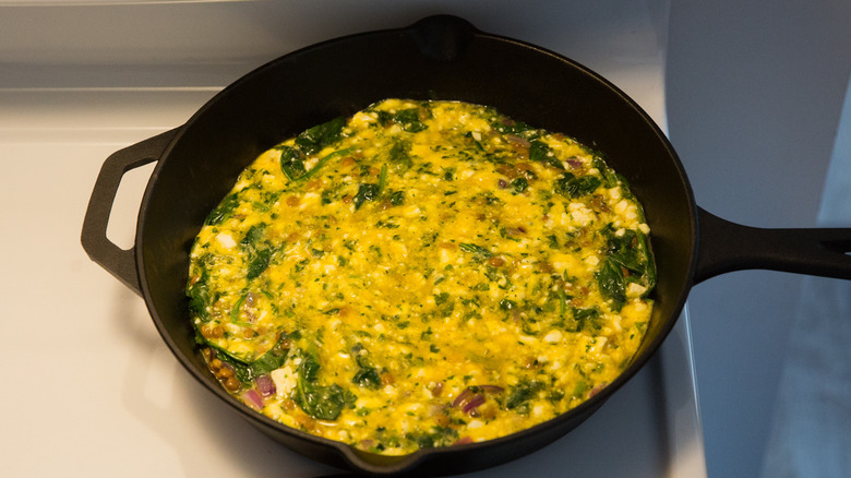 uncooked frittata in iron pan