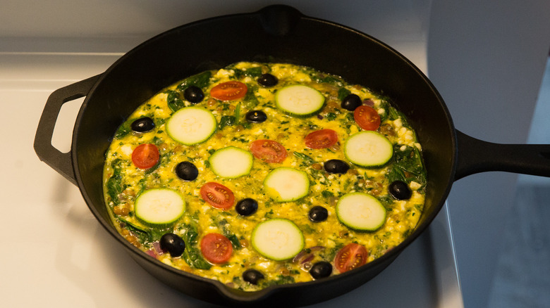 uncooked frittata in iron pan