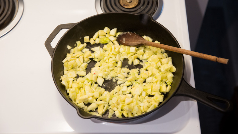 diced zucchini cooking in pan 