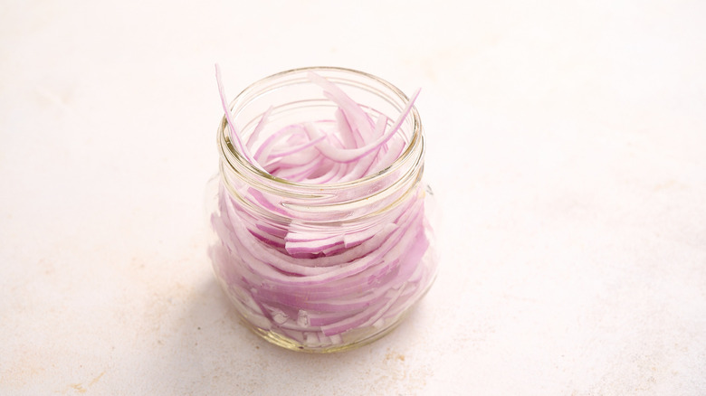 Red onions in a jar