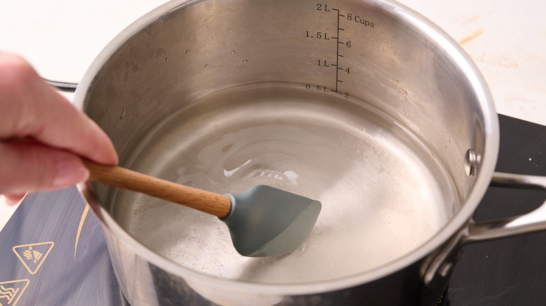 Stirring the sugar and water in a pot
