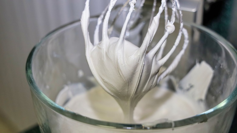 Royal icing and whisk in a mixing bowl