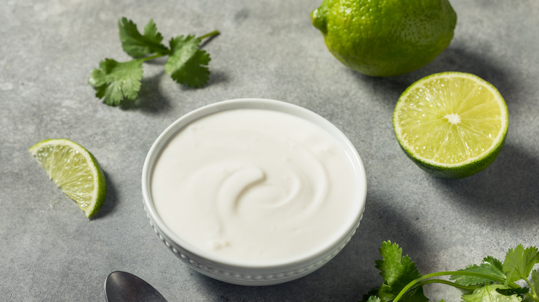Mexican crema beside lime and cilantro