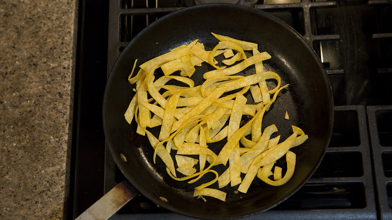 tortilla strips frying in pan