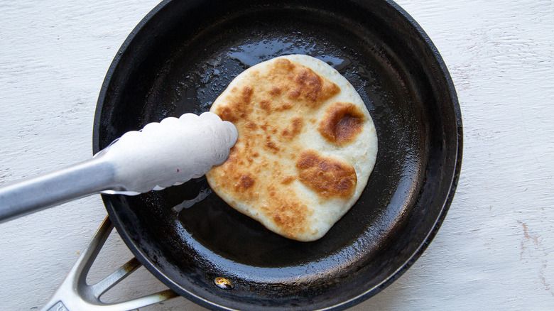 tortilla cooking in skillet