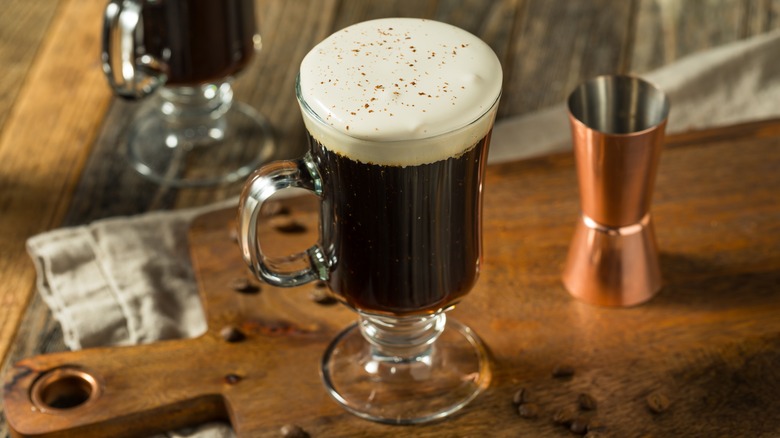 An Irish coffee served in a tall handled glass