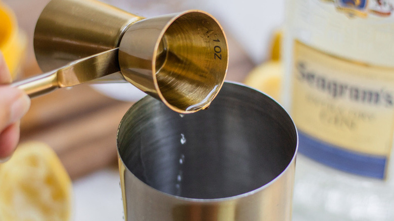 pouring alcohol into cocktail shaker