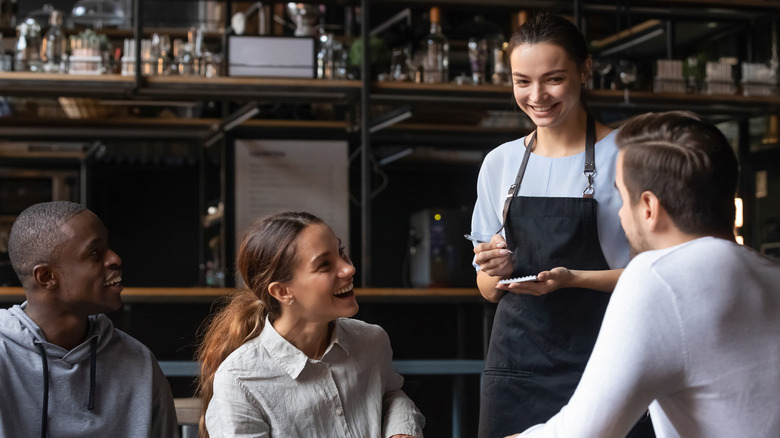 Server taking orders from customers