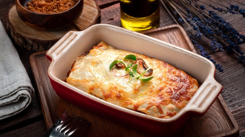 Lasagna in the pan with garnish leaves