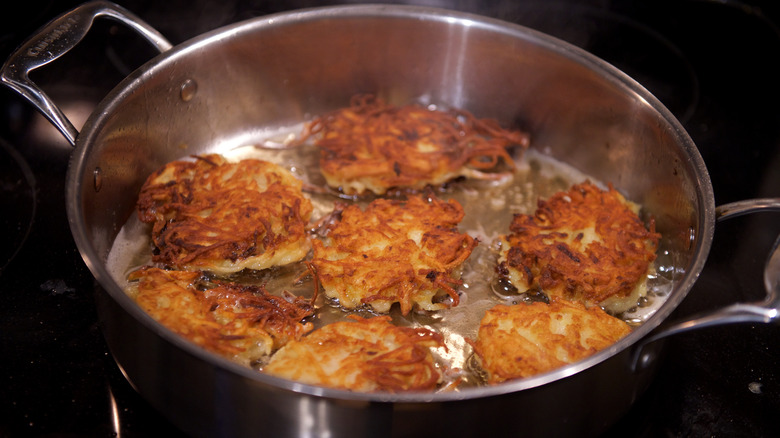 Latkes frying in oil.