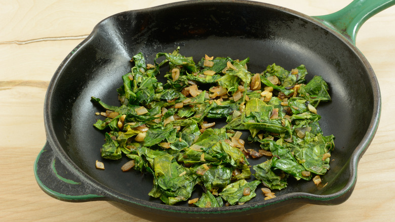 Sautéed collard greens in a cast iron skillet.