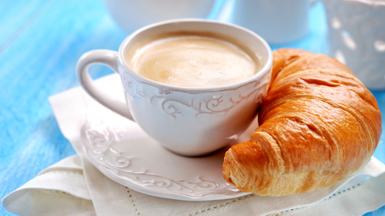 Cup of coffee with croissant