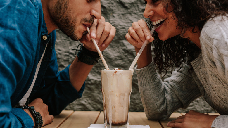 couple sharing a milkshake