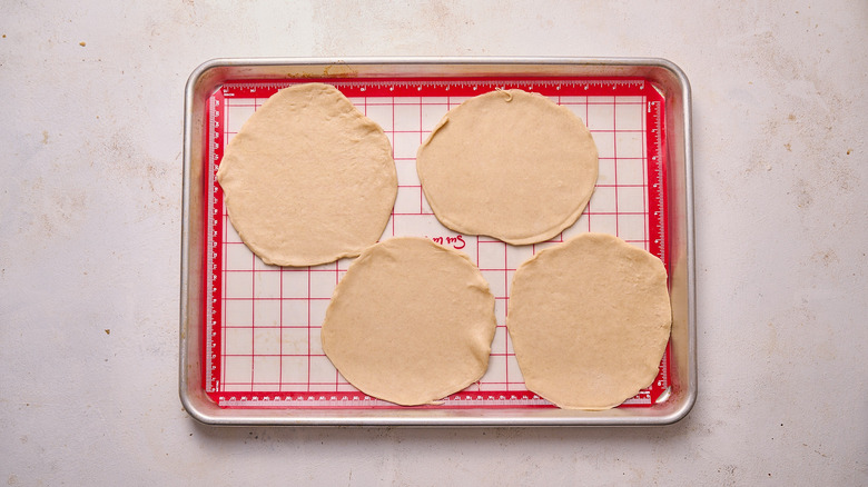 pastry cut into rounds on sheet tray