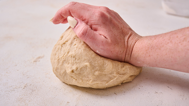 kneading dough on table