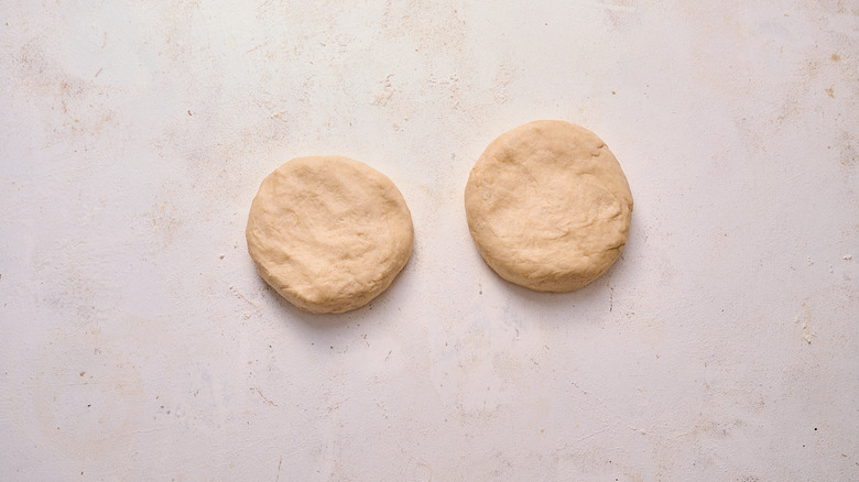 two discs of dough on table