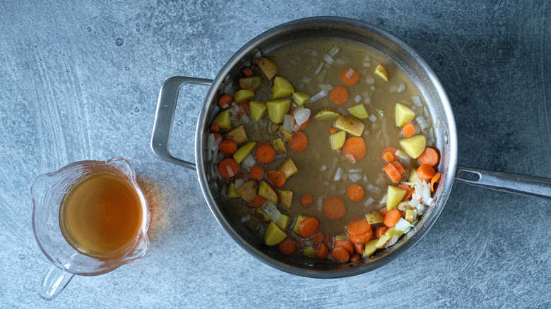 broth in skillet with vegetables