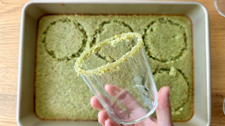 Pistachio cake cut with serving glass