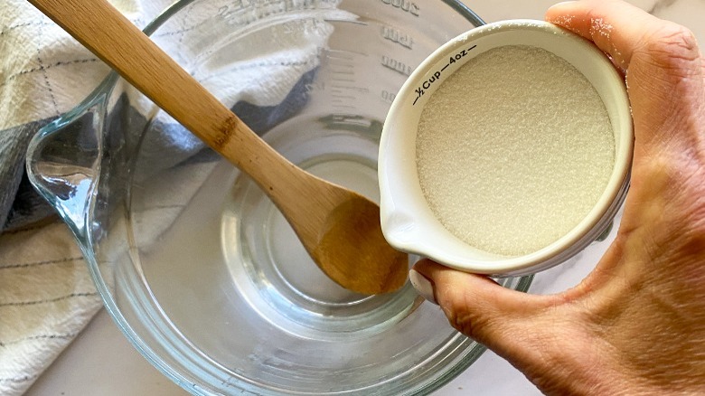 sugar being poured into water