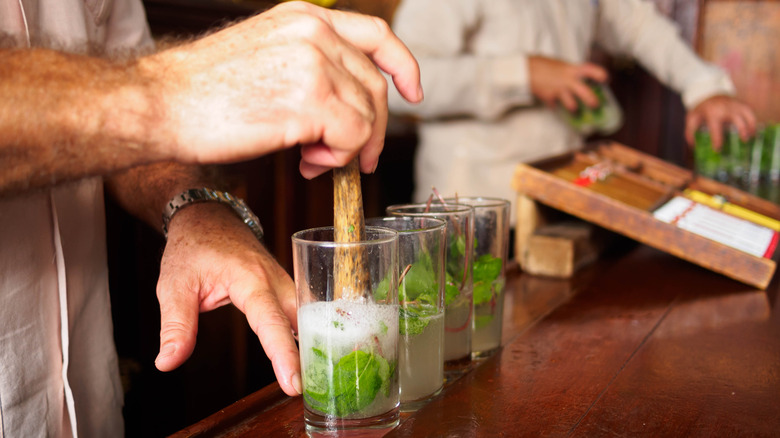 bartender muddling mint