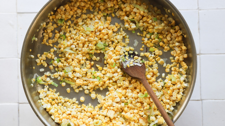 Corn and leeks in pan