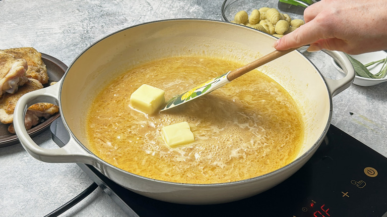 stirring butter into broth