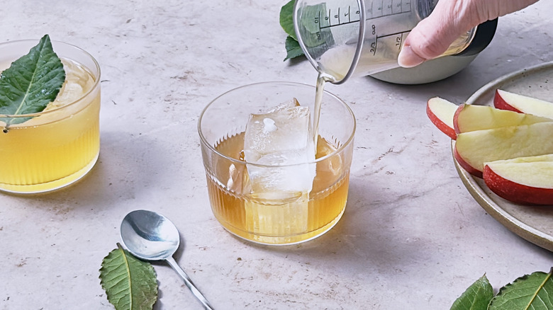 pouring apple cider over ice