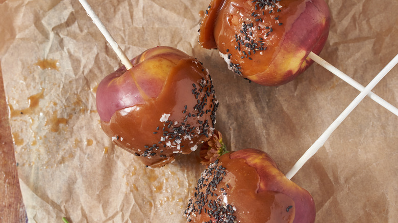 caramel apples on parchment paper