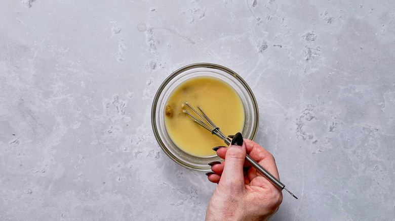 whisking miso into water