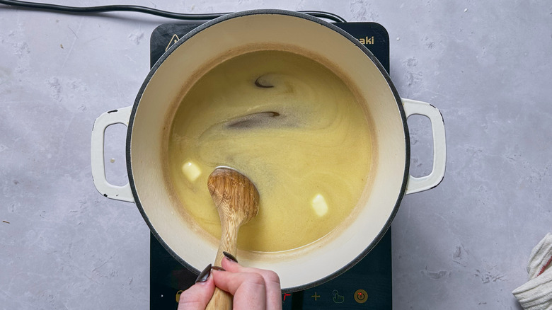 stirring butter in pot